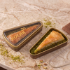 Koçak havüç dilim baklava in an elegant triangle box. Rich Antep pistachio filling, traditional Turkish dessert. Perfect gift, 150g, made in Türkiye.
